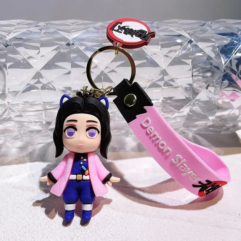 3D Demon Slayer Keychains featuring cute anime character dolls like Tanjiro and Nezuko, used as car ignition accessories and backpack pendants.