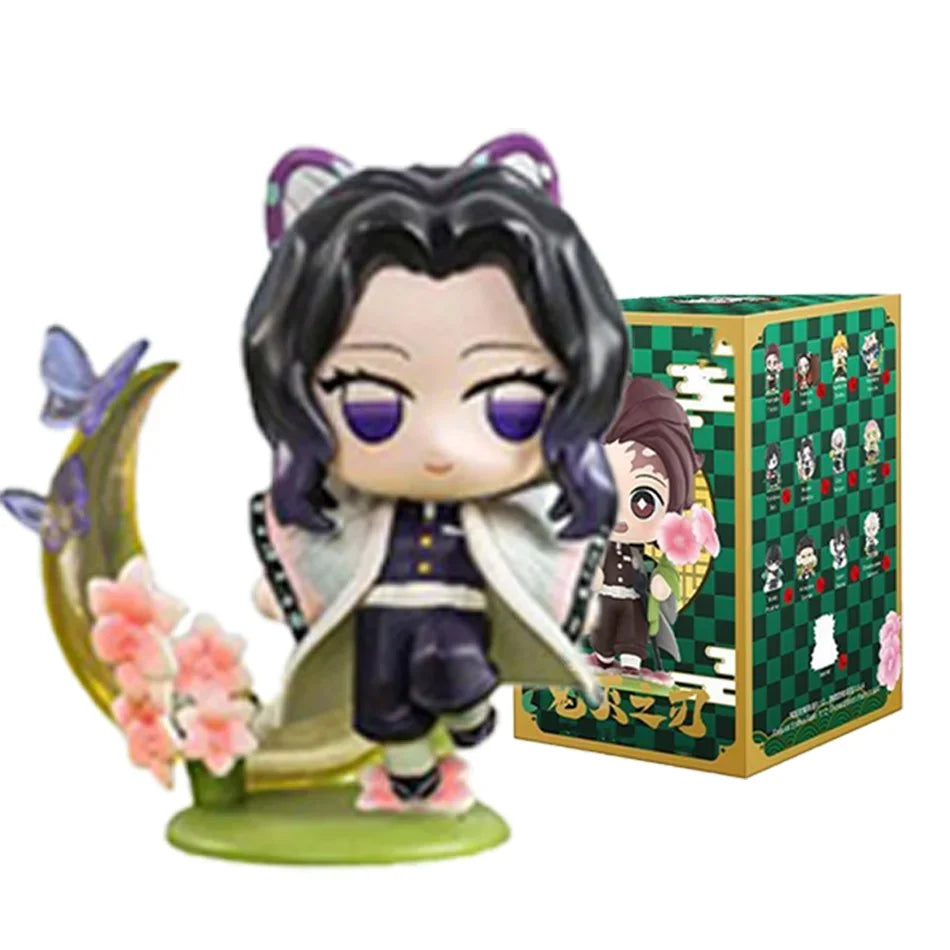 A colorful Demon Slayer Blind Box containing a random cute PVC anime figure of Tanjiro or Nezuko, used as a desktop ornament.