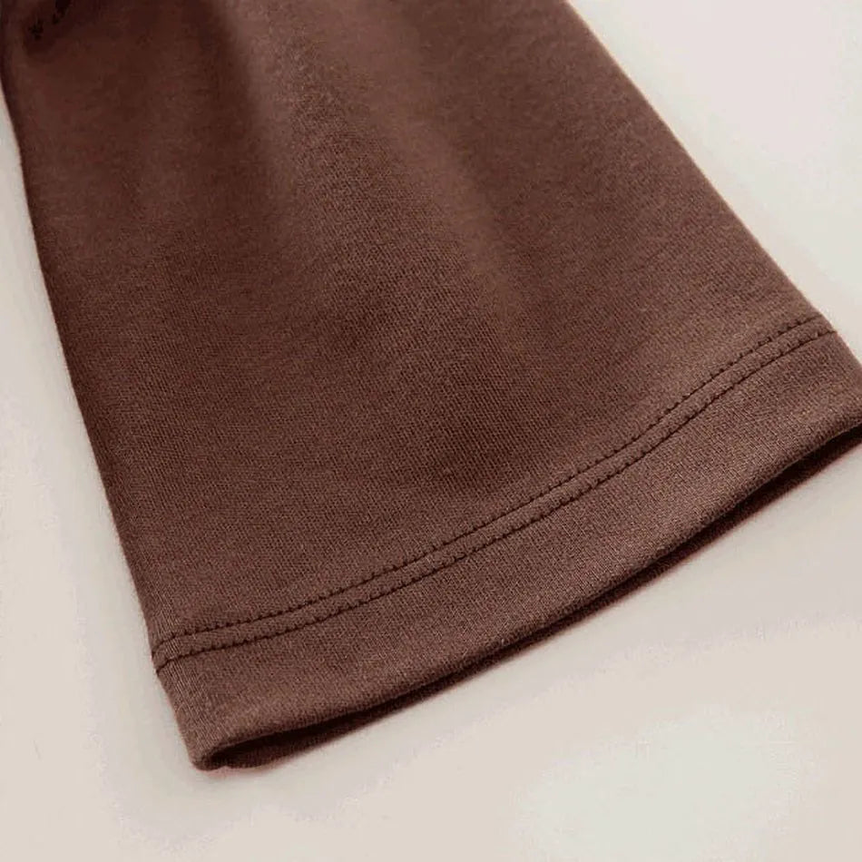 A newborn infant wearing one of the Anime Baby Rompers, a cosplay costume available in Akatsuki, Nezuko, and Tanjirou styles.