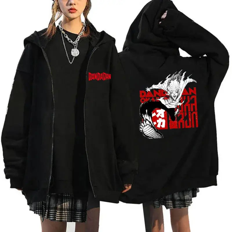 A youthful female model wearing the funny designer Dandadan Okarun Zip Up Hoodie with an anime and manga print.