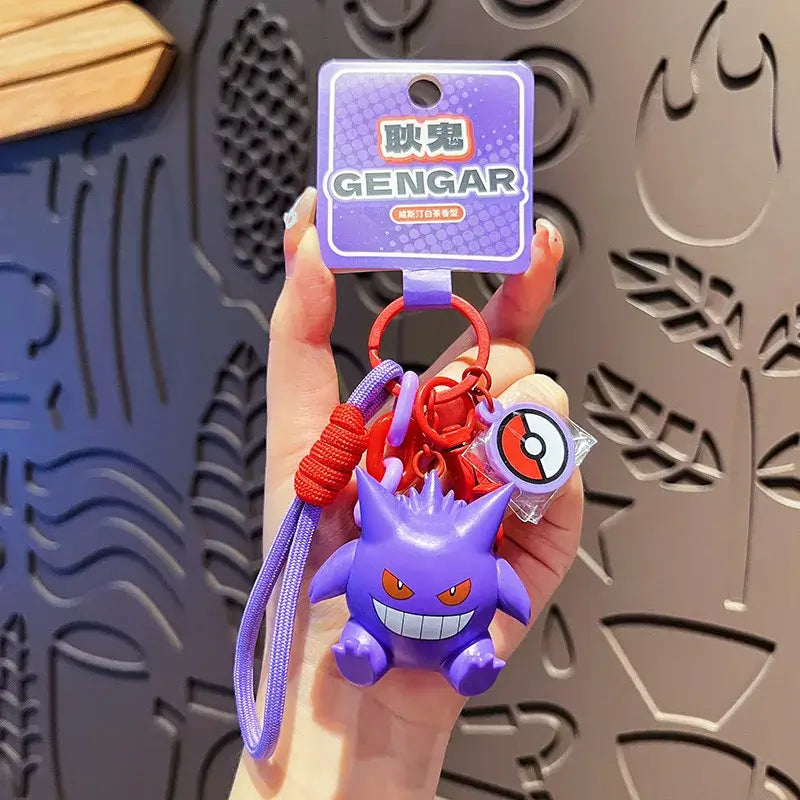 A Genuine Pokemon Keychain featuring a 3D Pikachu and Gengar anime action figure with a fragrance pendant design for backpacks.