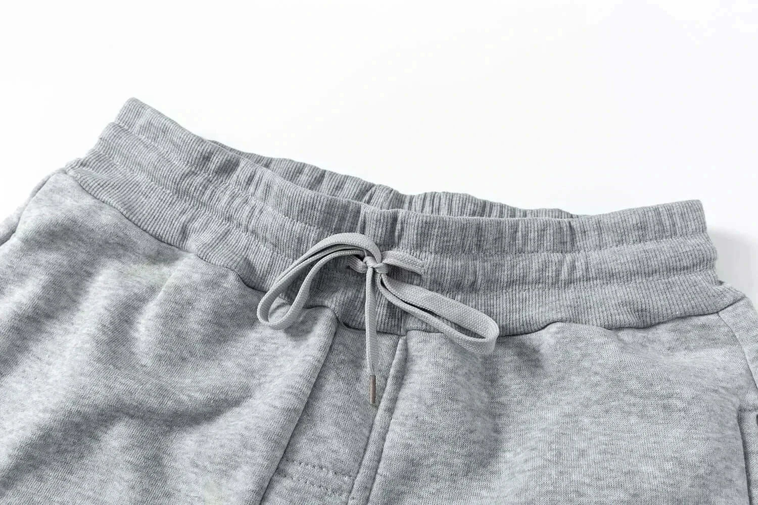 A man wearing the loose-fit Demon Slayer Anime Men Sweatpants with a Japanese cartoon print, showcasing a casual hip hop and Y2K streetwear style.