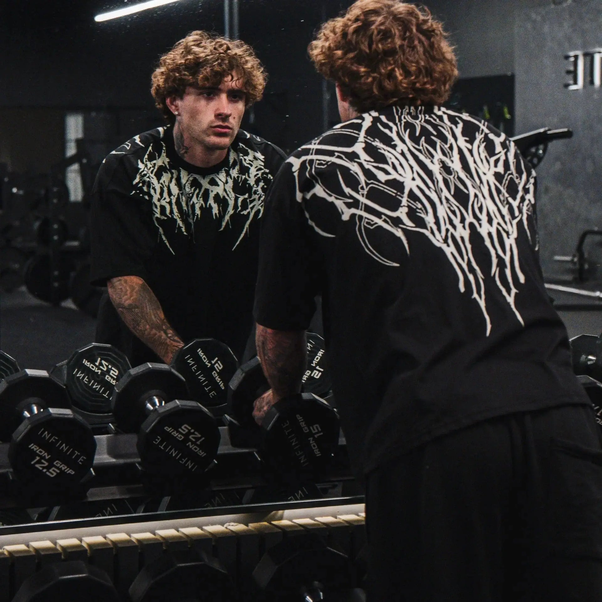 Dark Oversized Cotton Tee Skull Print shown on a model, highlighting the alternative fashion style suitable for men and women's streetwear and gym workouts.