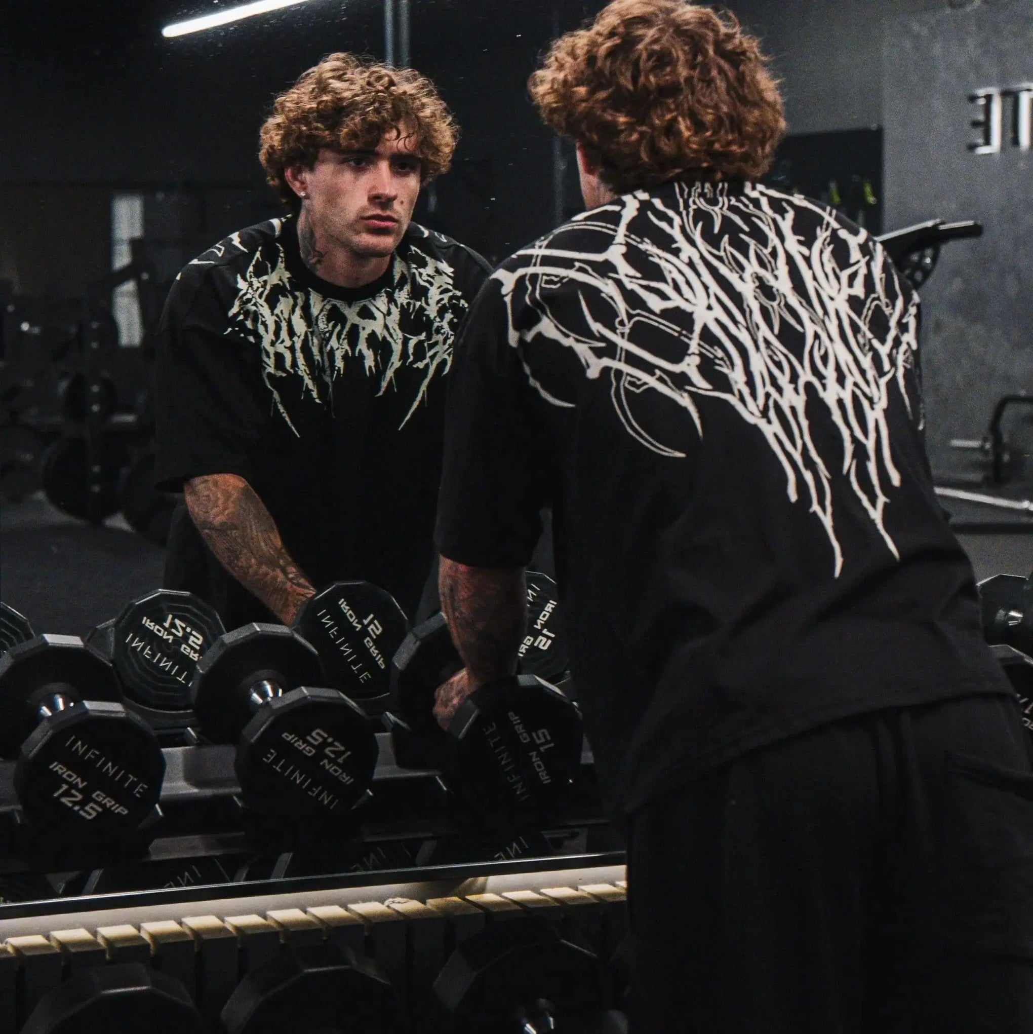 Dark Oversized Cotton Tee Skull Print shown on a model, highlighting the alternative fashion style suitable for men and women's streetwear and gym workouts.