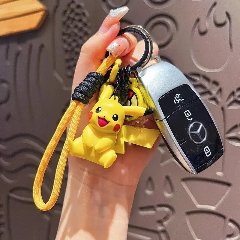 A Genuine Pokemon Keychain featuring a 3D Pikachu and Gengar anime action figure with a fragrance pendant design for backpacks.