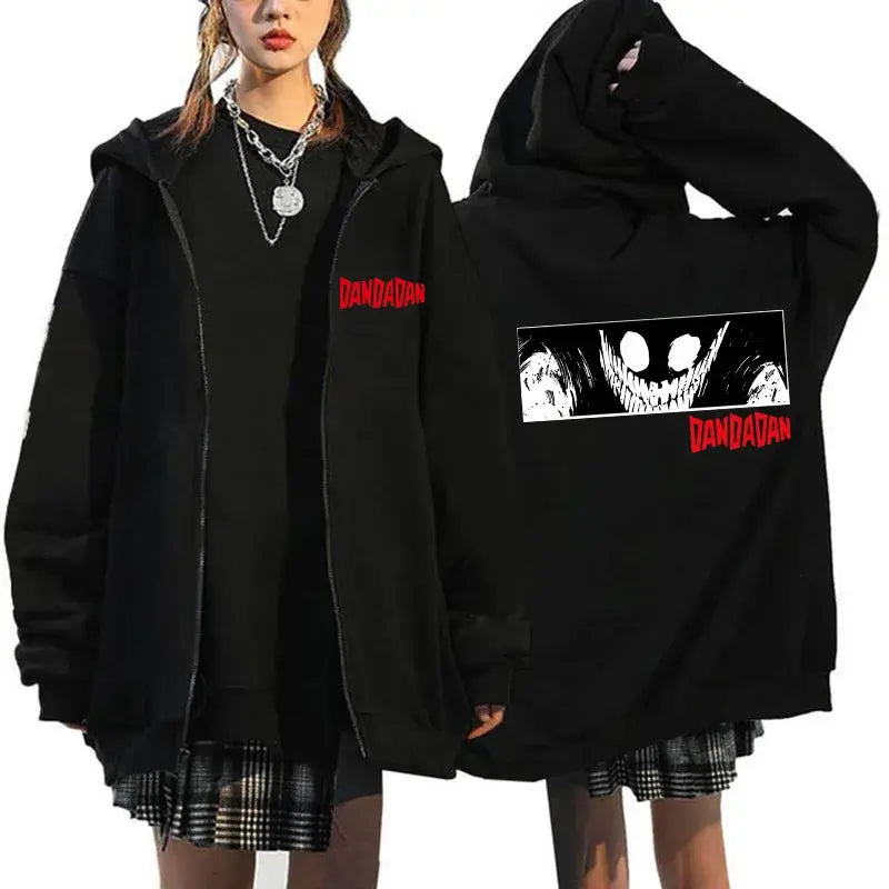 A youthful female model wearing the funny designer Dandadan Okarun Zip Up Hoodie with an anime and manga print.