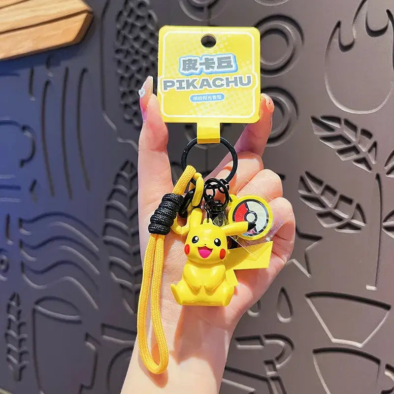 A Genuine Pokemon Keychain featuring a 3D Pikachu and Gengar anime action figure with a fragrance pendant design for backpacks.