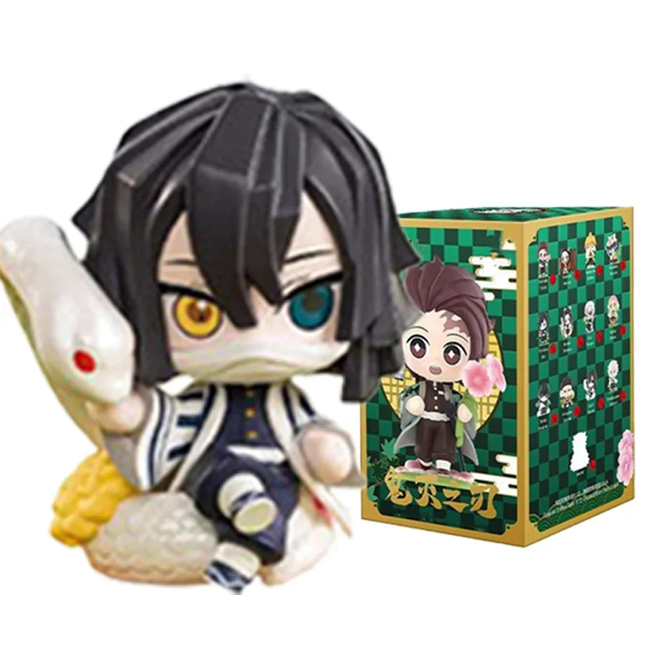 A colorful Demon Slayer Blind Box containing a random cute PVC anime figure of Tanjiro or Nezuko, used as a desktop ornament.