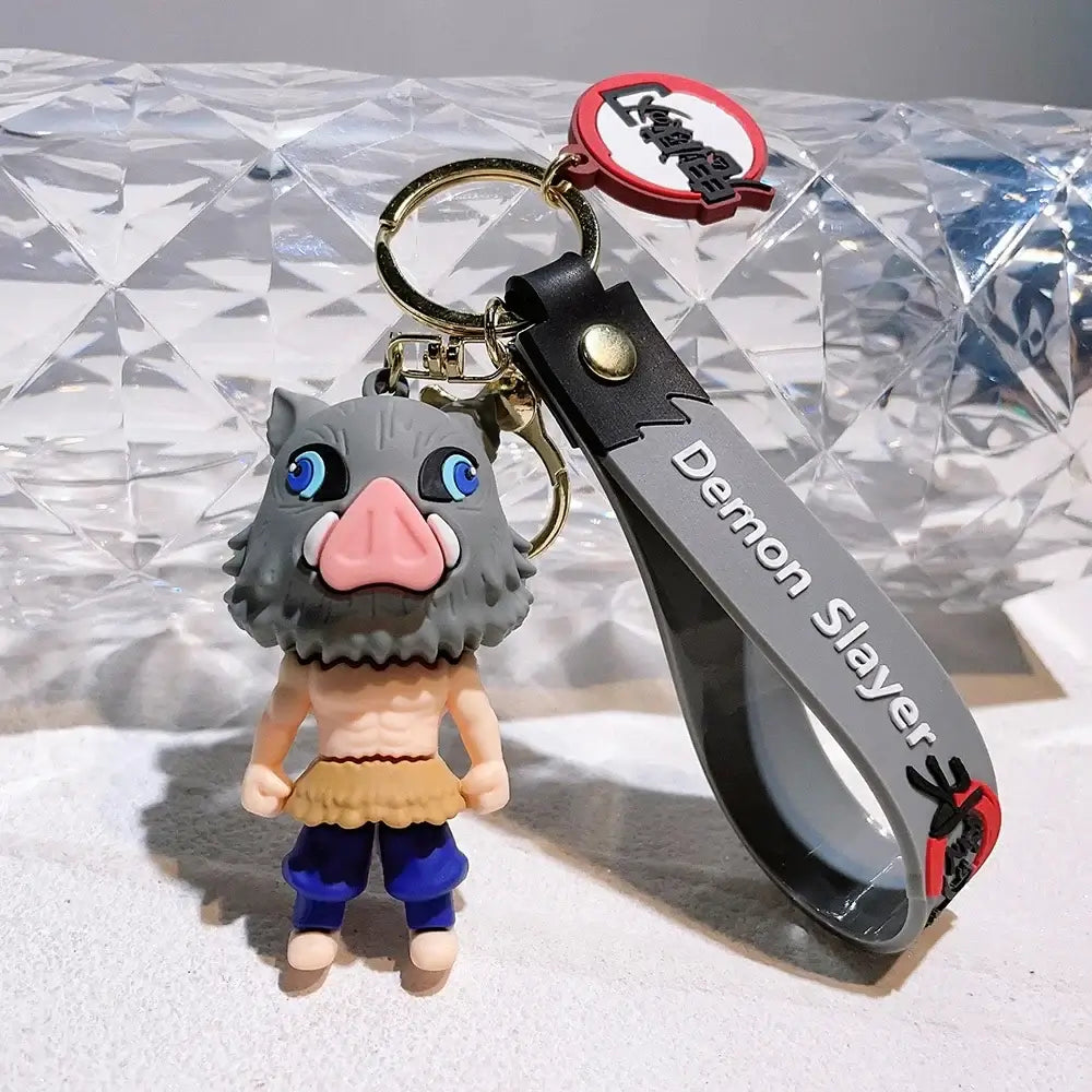 3D Demon Slayer Keychains featuring cute anime character dolls like Tanjiro and Nezuko, used as car ignition accessories and backpack pendants.