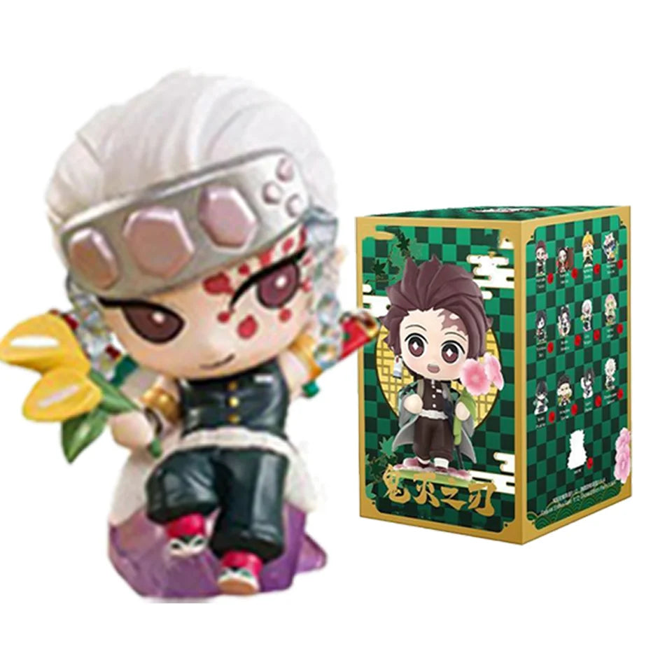 A colorful Demon Slayer Blind Box containing a random cute PVC anime figure of Tanjiro or Nezuko, used as a desktop ornament.