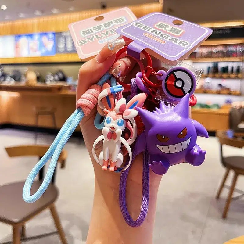 A Genuine Pokemon Keychain featuring a 3D Pikachu and Gengar anime action figure with a fragrance pendant design for backpacks.
