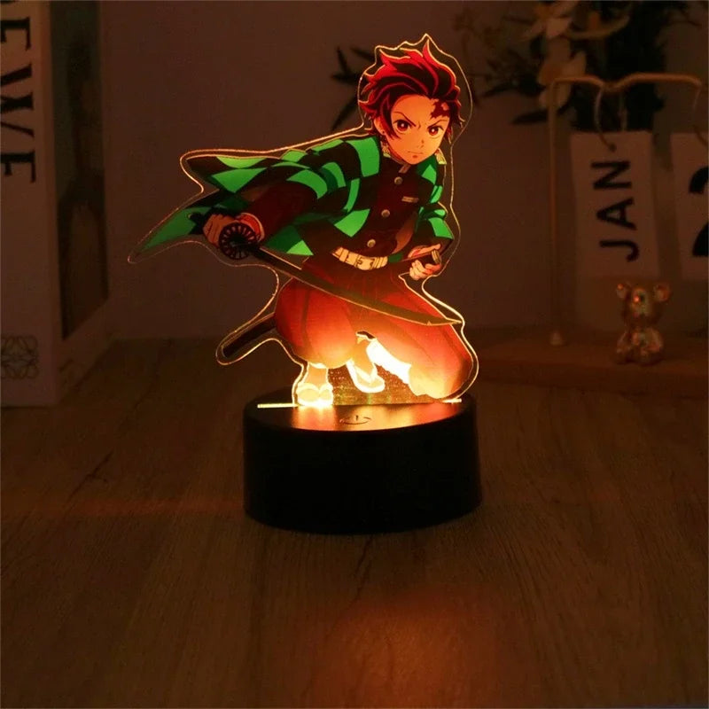 A glowing Demon Slayer 3D Lamp featuring an acrylic Tanjiro and Nezuko figure design, illuminated in blue LED light for bedroom decor.