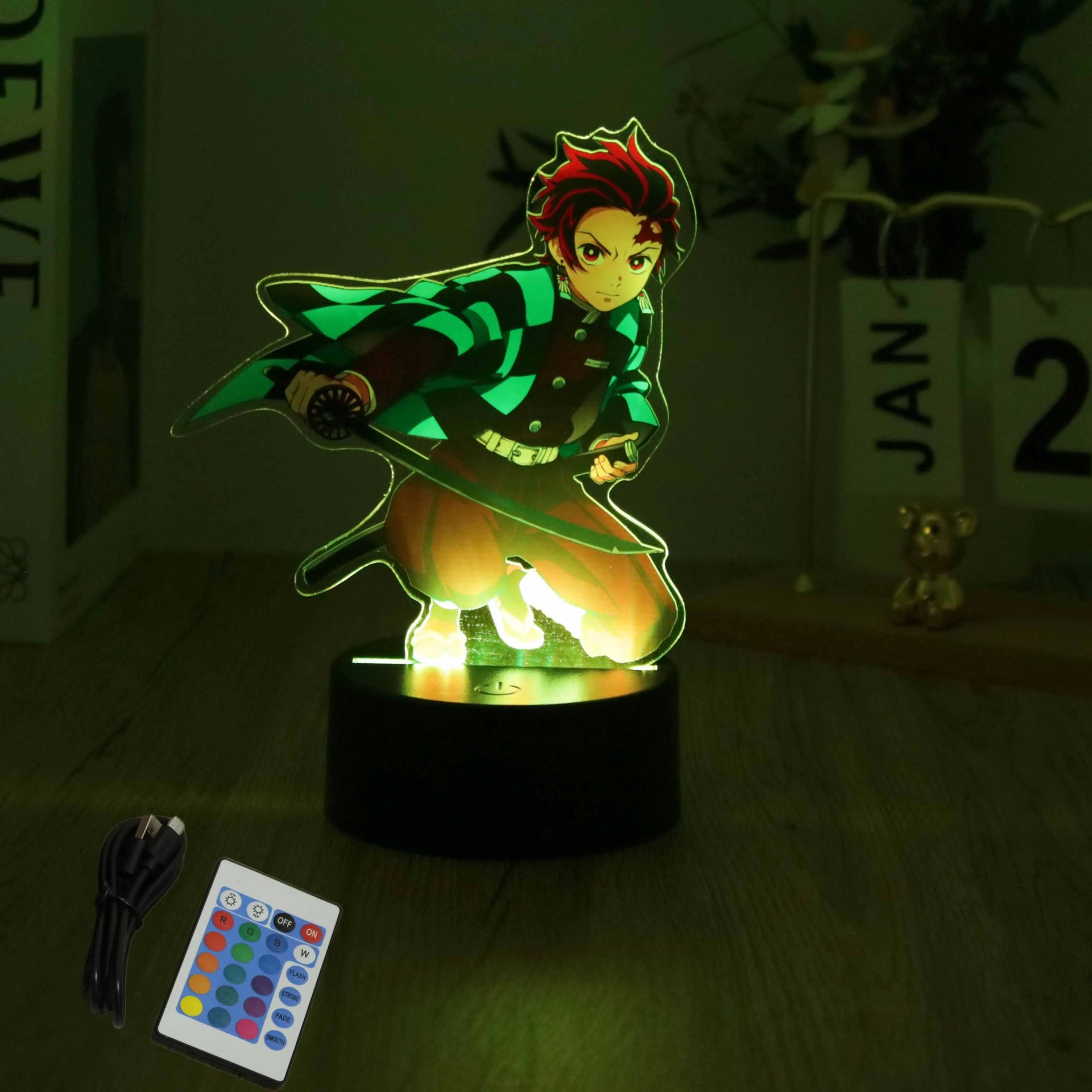 A glowing Demon Slayer 3D Lamp featuring an acrylic Tanjiro and Nezuko figure design, illuminated in blue LED light for bedroom decor.