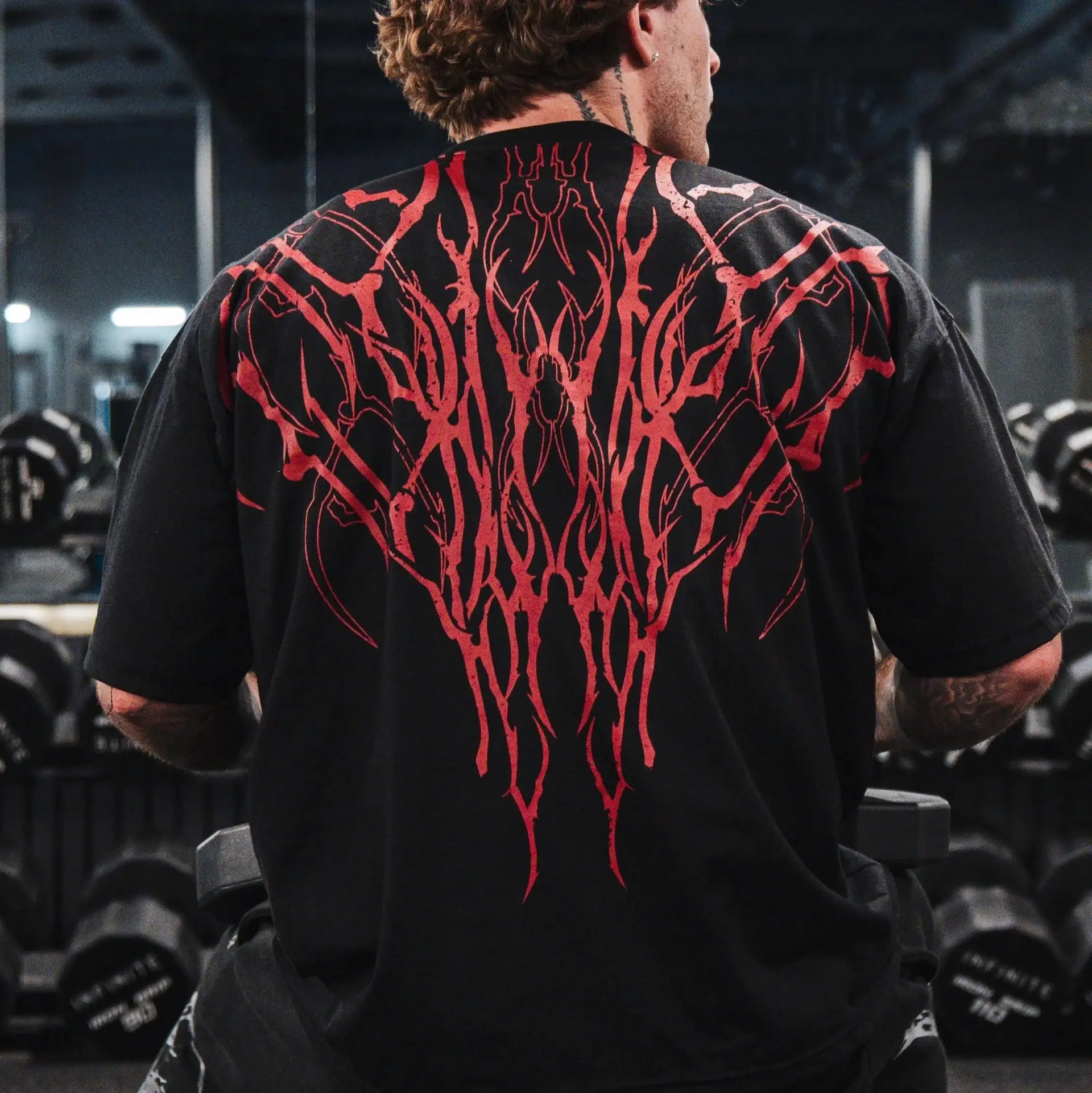 Dark Oversized Cotton Tee Skull Print shown on a model, highlighting the alternative fashion style suitable for men and women's streetwear and gym workouts.