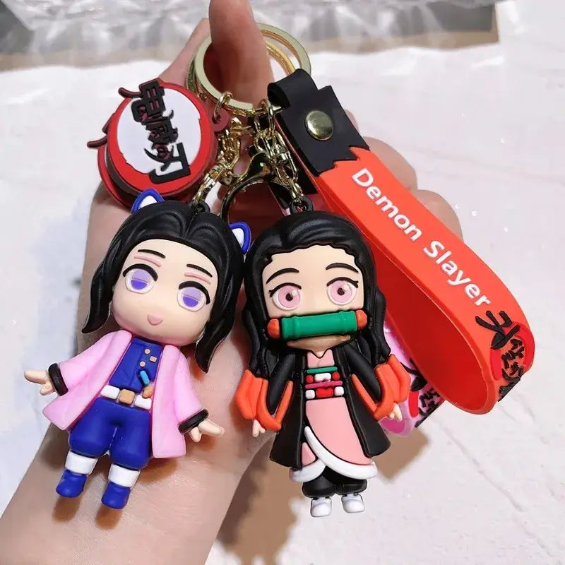 3D Demon Slayer Keychains featuring cute anime character dolls like Tanjiro and Nezuko, used as car ignition accessories and backpack pendants.