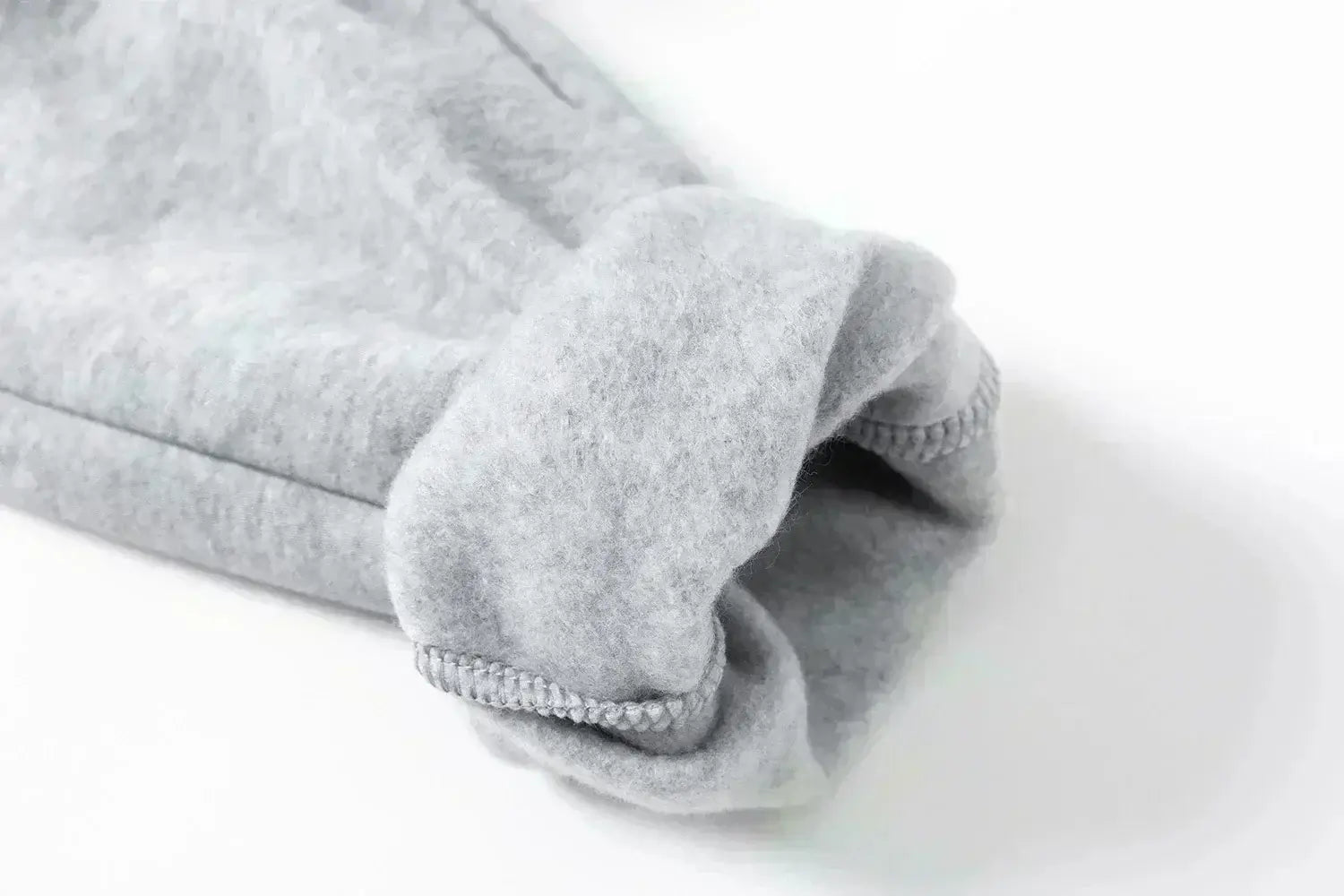 A man wearing the loose-fit Demon Slayer Anime Men Sweatpants with a Japanese cartoon print, showcasing a casual hip hop and Y2K streetwear style.