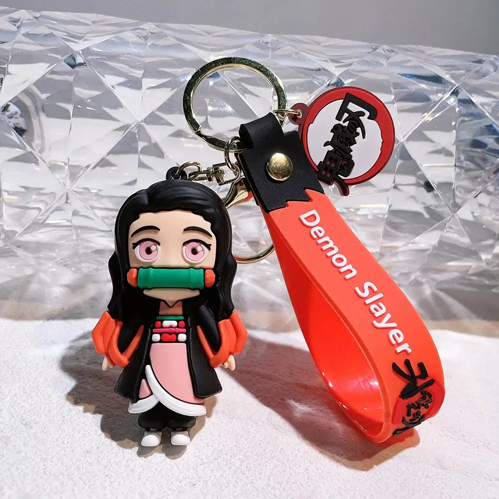 3D Demon Slayer Keychains featuring cute anime character dolls like Tanjiro and Nezuko, used as car ignition accessories and backpack pendants.