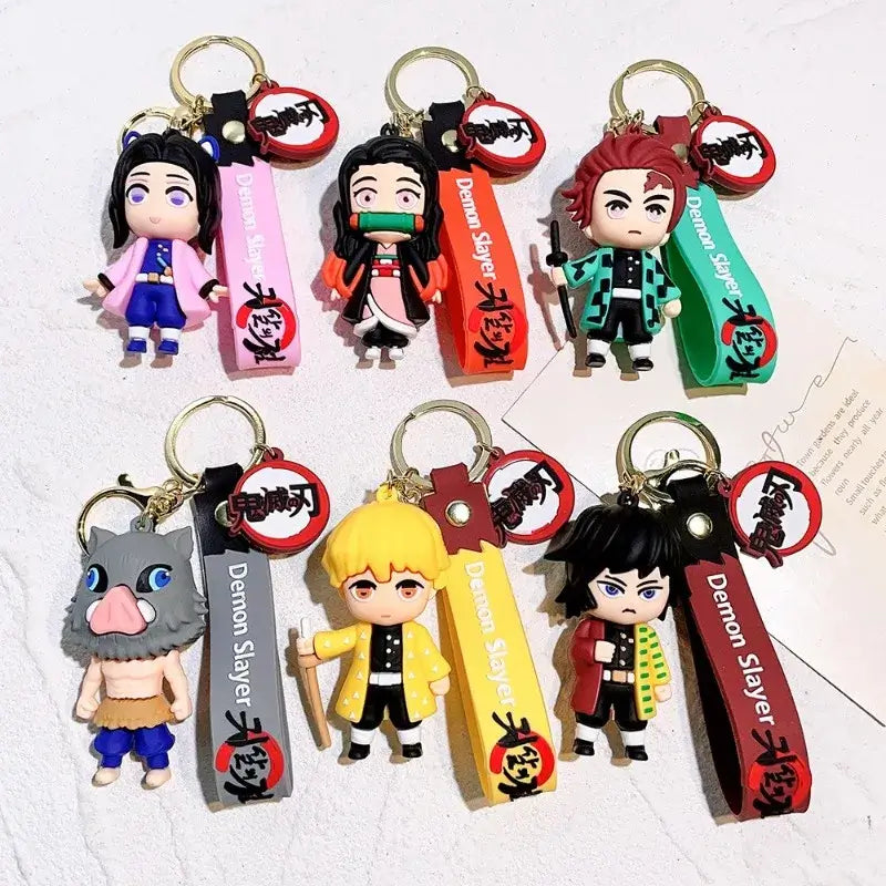 3D Demon Slayer Keychains featuring cute anime character dolls like Tanjiro and Nezuko, used as car ignition accessories and backpack pendants.
