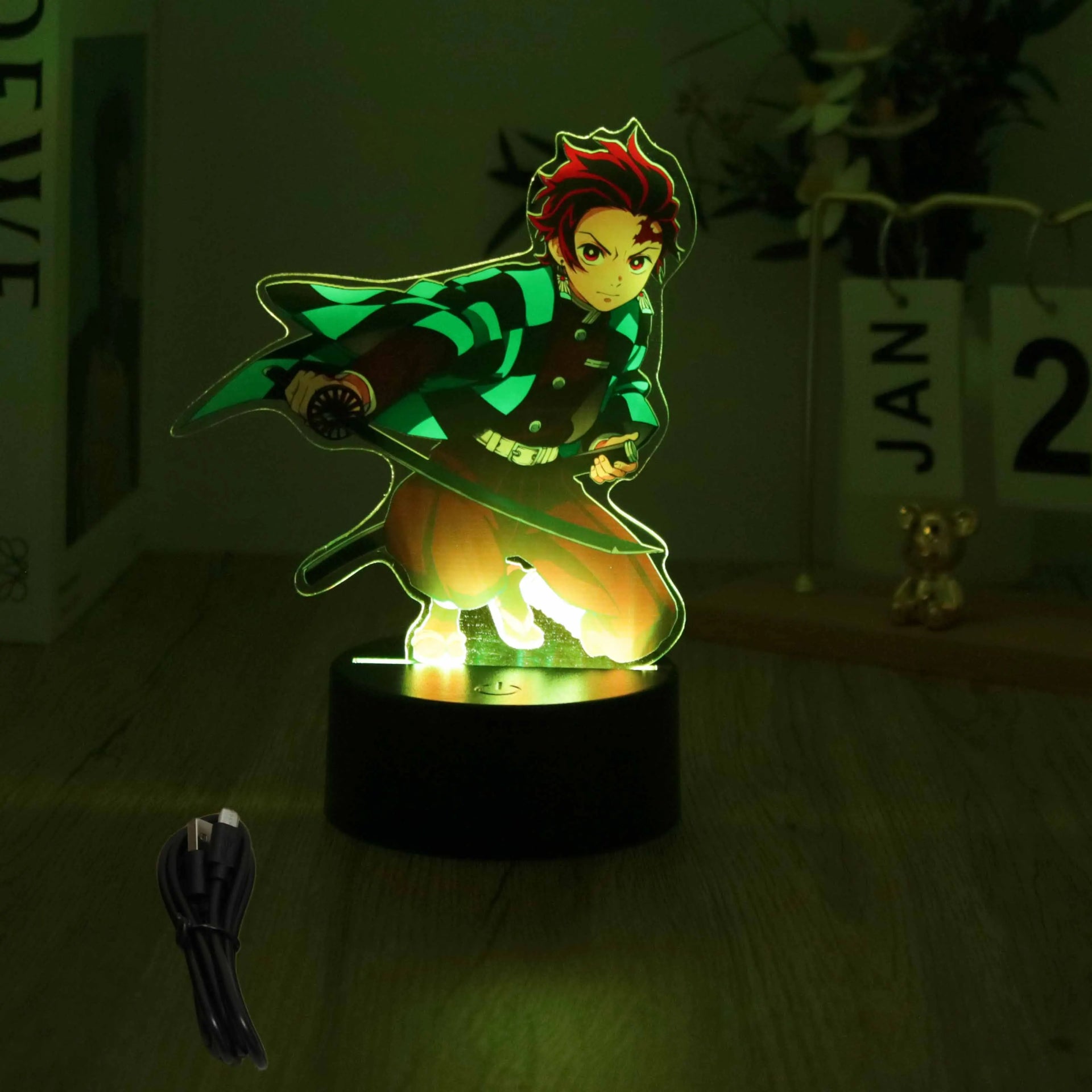 A glowing Demon Slayer 3D Lamp featuring an acrylic Tanjiro and Nezuko figure design, illuminated in blue LED light for bedroom decor.