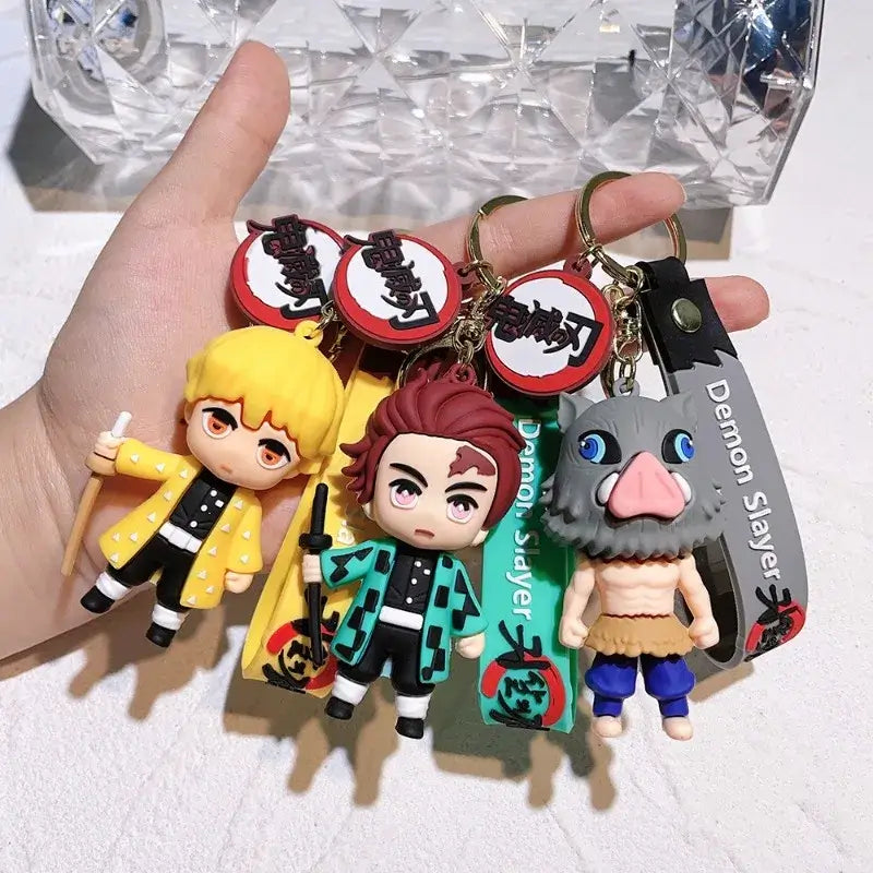 3D Demon Slayer Keychains featuring cute anime character dolls like Tanjiro and Nezuko, used as car ignition accessories and backpack pendants.