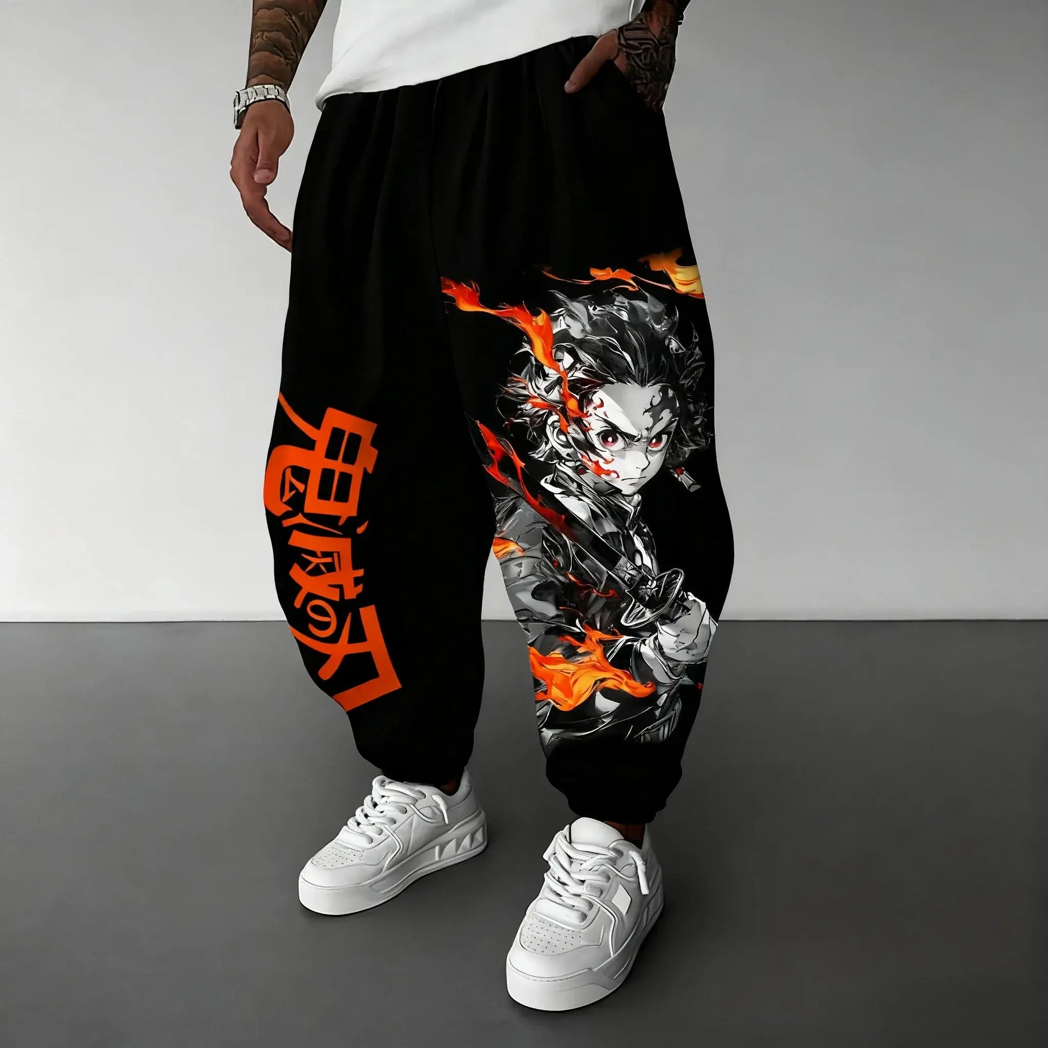 A man wearing the loose-fit Demon Slayer Anime Men Sweatpants with a Japanese cartoon print, showcasing a casual hip hop and Y2K streetwear style.