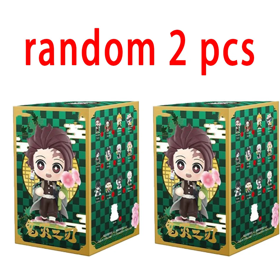 A colorful Demon Slayer Blind Box containing a random cute PVC anime figure of Tanjiro or Nezuko, used as a desktop ornament.