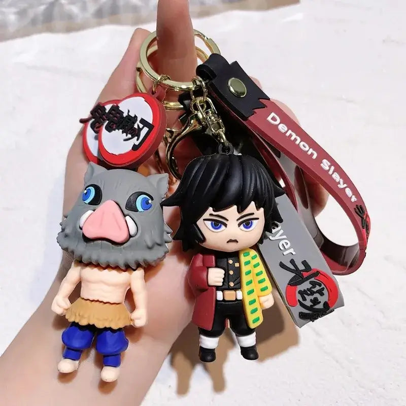 3D Demon Slayer Keychains featuring cute anime character dolls like Tanjiro and Nezuko, used as car ignition accessories and backpack pendants.